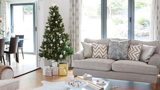Neutral coloured living room with Christmas tree in center