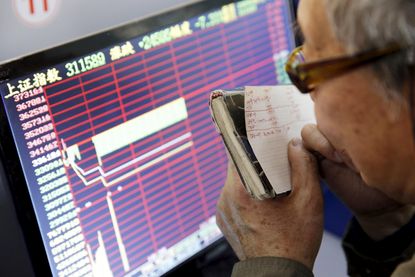 A Chinese investor tracks stocks on a screen.