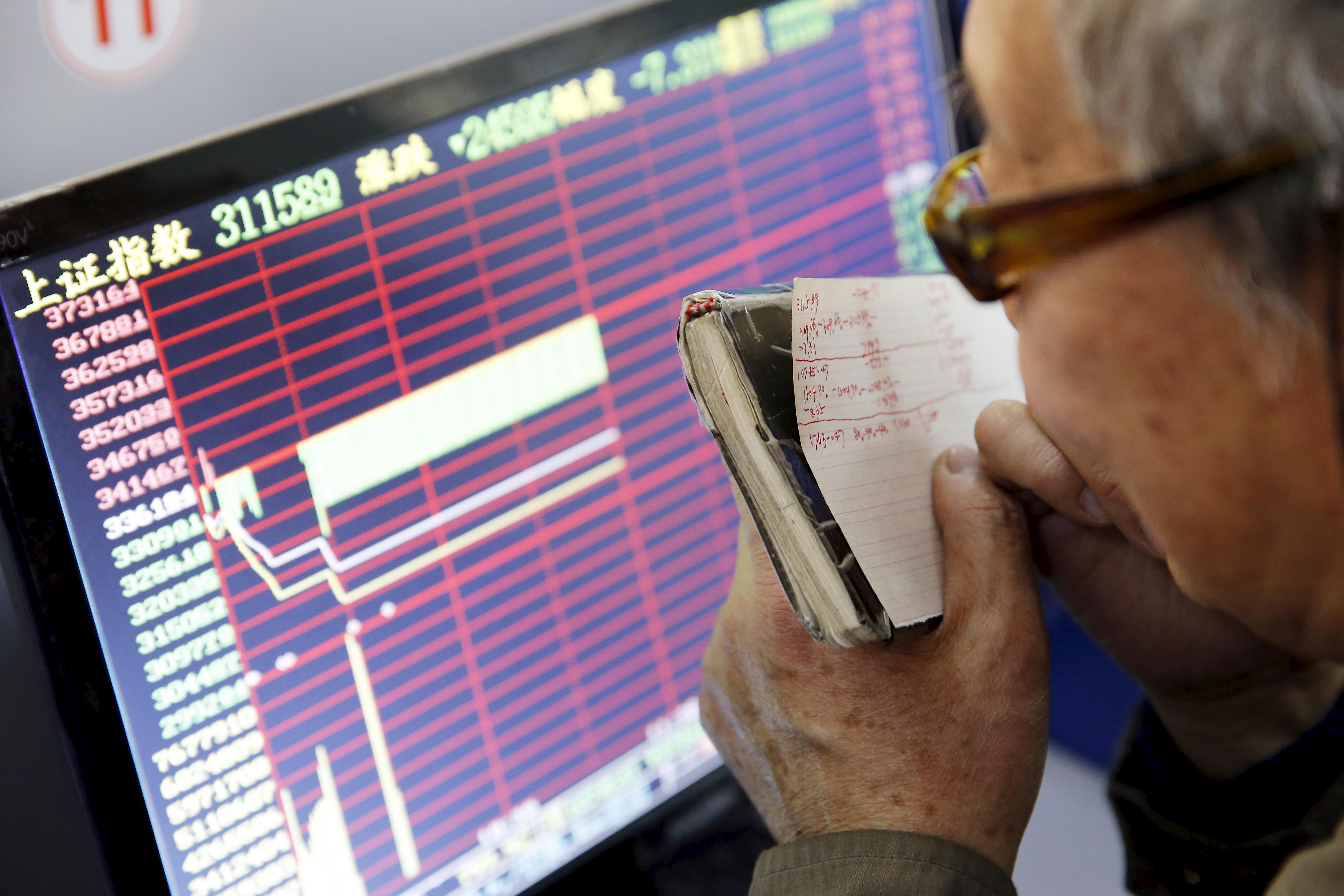 A Chinese investor tracks stocks on a screen.