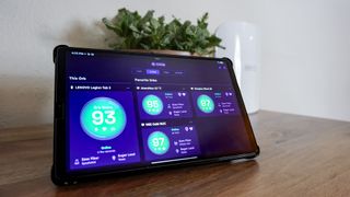 The Orb app running on a tablet in front of an eero Wi-Fi 7 router