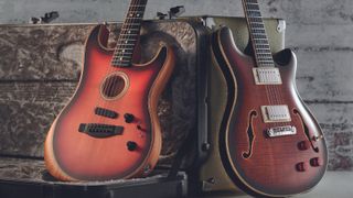 Fender Acoustasonic (left) and PRS semi-hollow guitars, with a case and amp