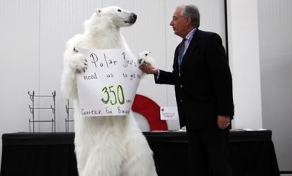 A UN delegate (right) disputes the claim of polar bear decline with an activist during the Cancun conference.