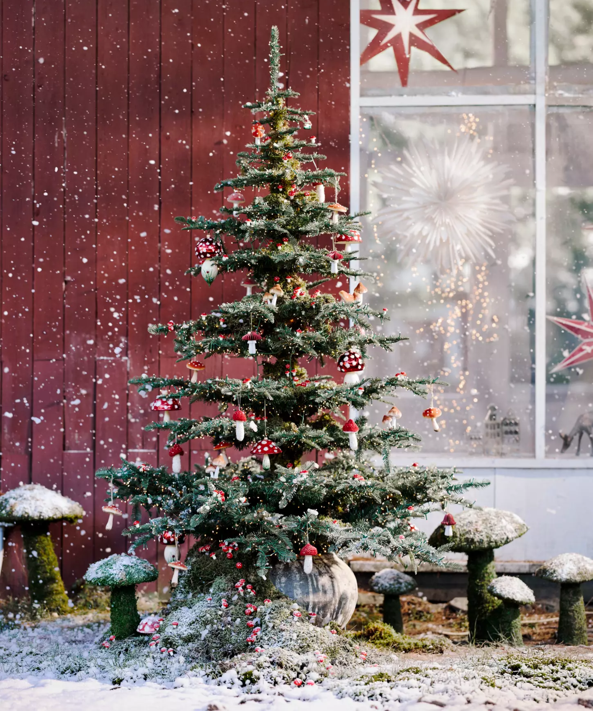 Charlie Brown Christmas tree pictured outdoors with quirky mushroom ornaments and faux snow