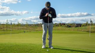 PGA pro John Howells setting up to hit a pitch shot at JCB Golf Club