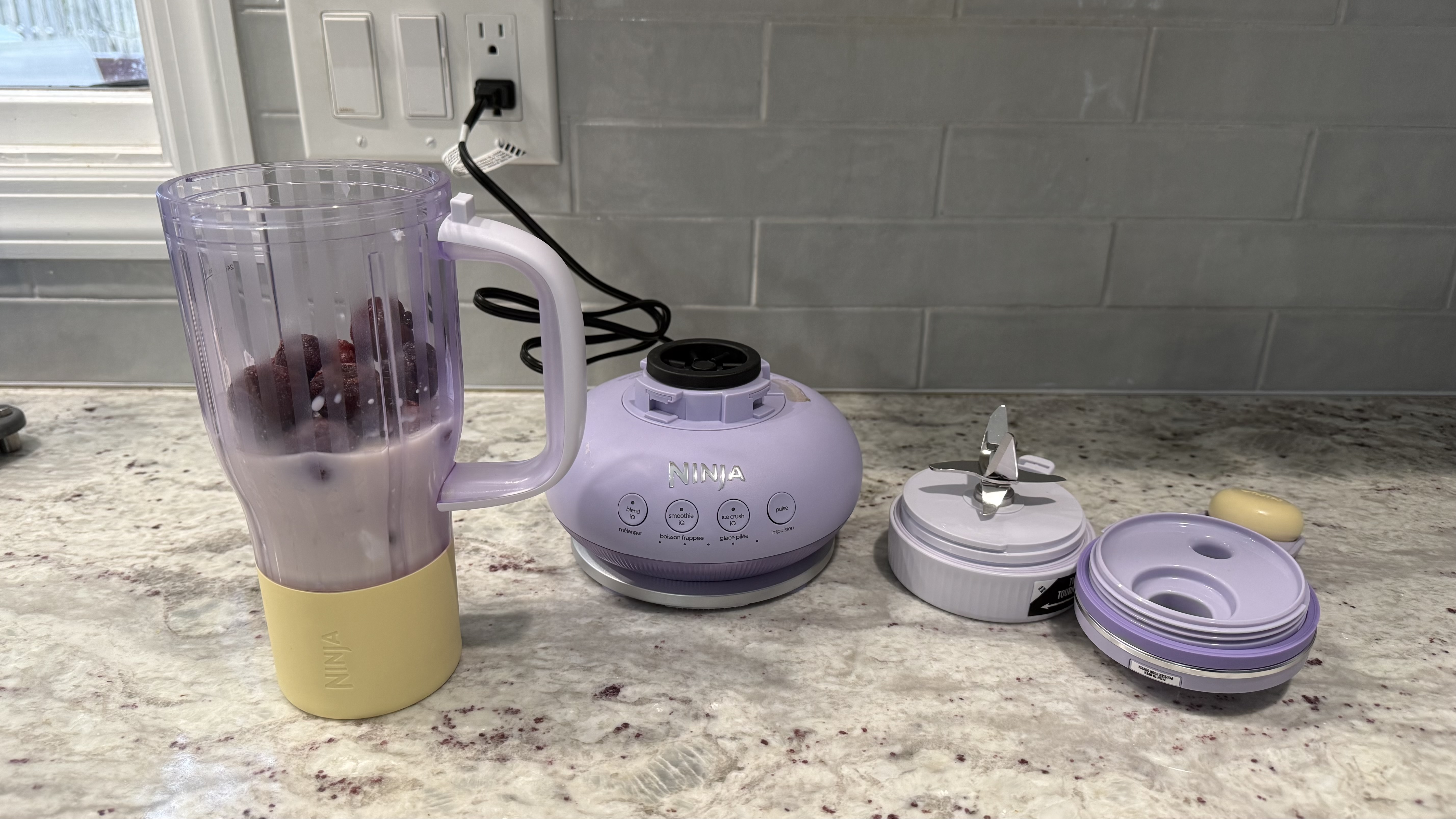 Ninja BlendBOSS&trade; Tumbler Blender with 26oz Travel Tumbler making a cherry smoothie