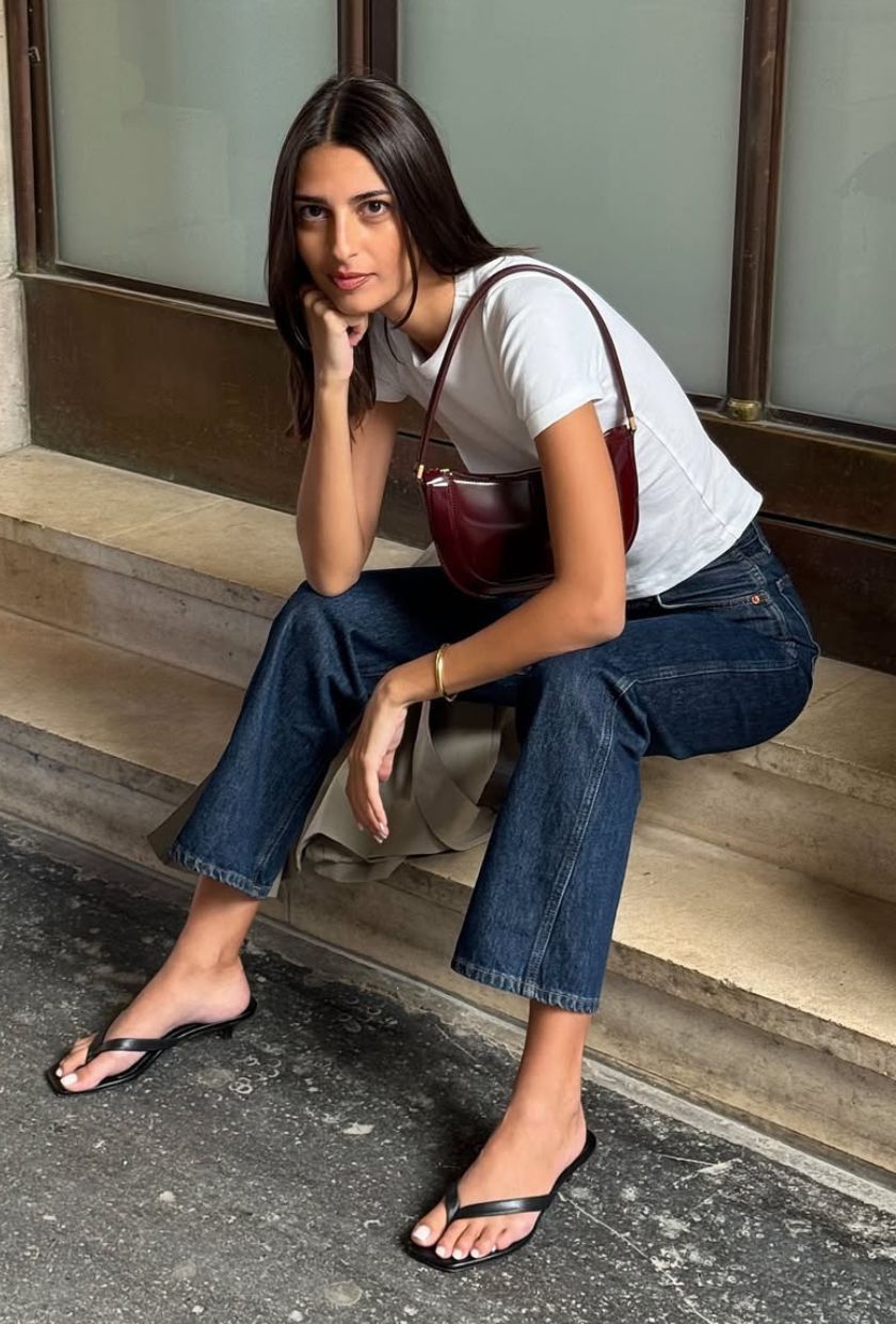 @salome.mory wears cropped flare jeans with a t-shirt and thong sandals