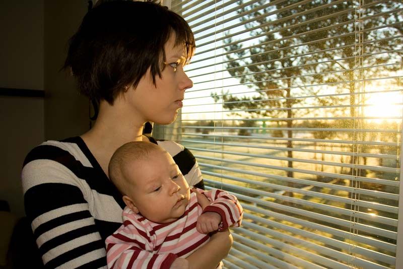 depressed mom holding her baby