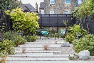 Modern garden ideas: long plank stone paving with gravel surround