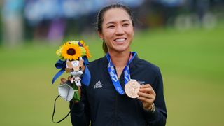 Lydia Ko holds her bronze medal on the podium during the victory ceremony of the womens golf individual stroke play during the Tokyo 2020 Olympic Games