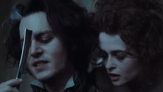 Johnny Depp holding a razor while Helena Bonham Carter looks on in Sweeney Todd