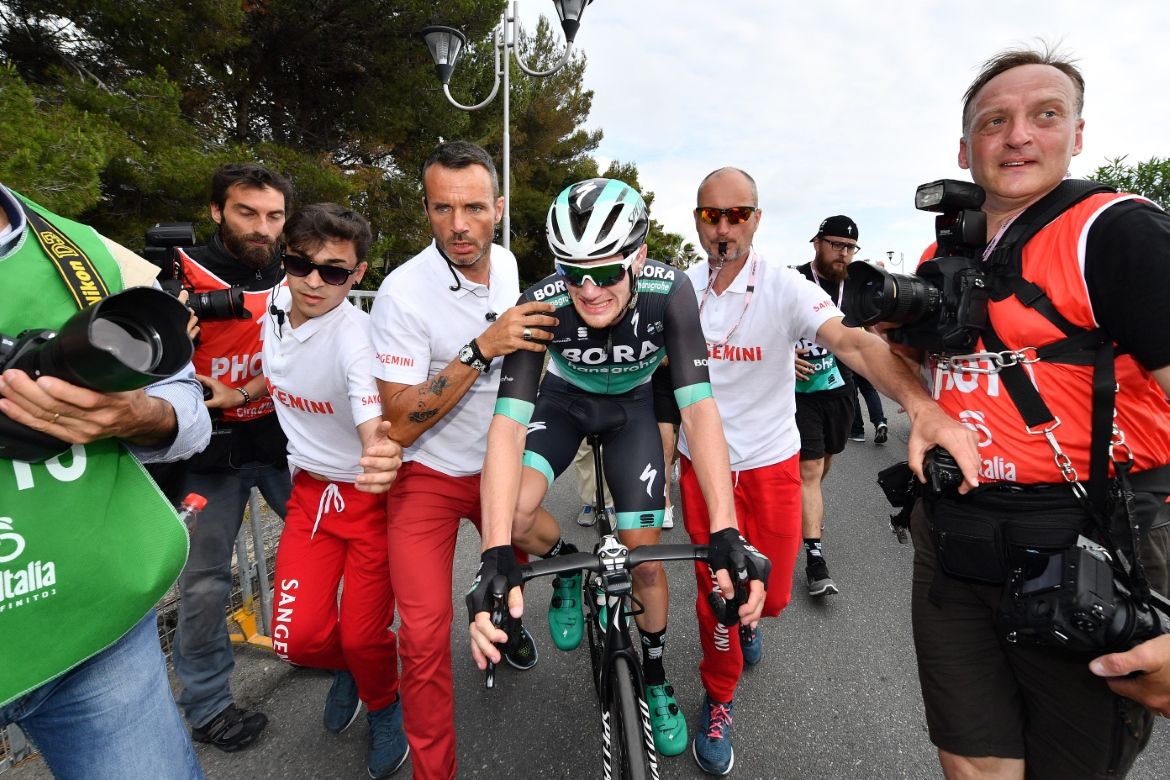 Sam Bennett is shepherded towards the podium