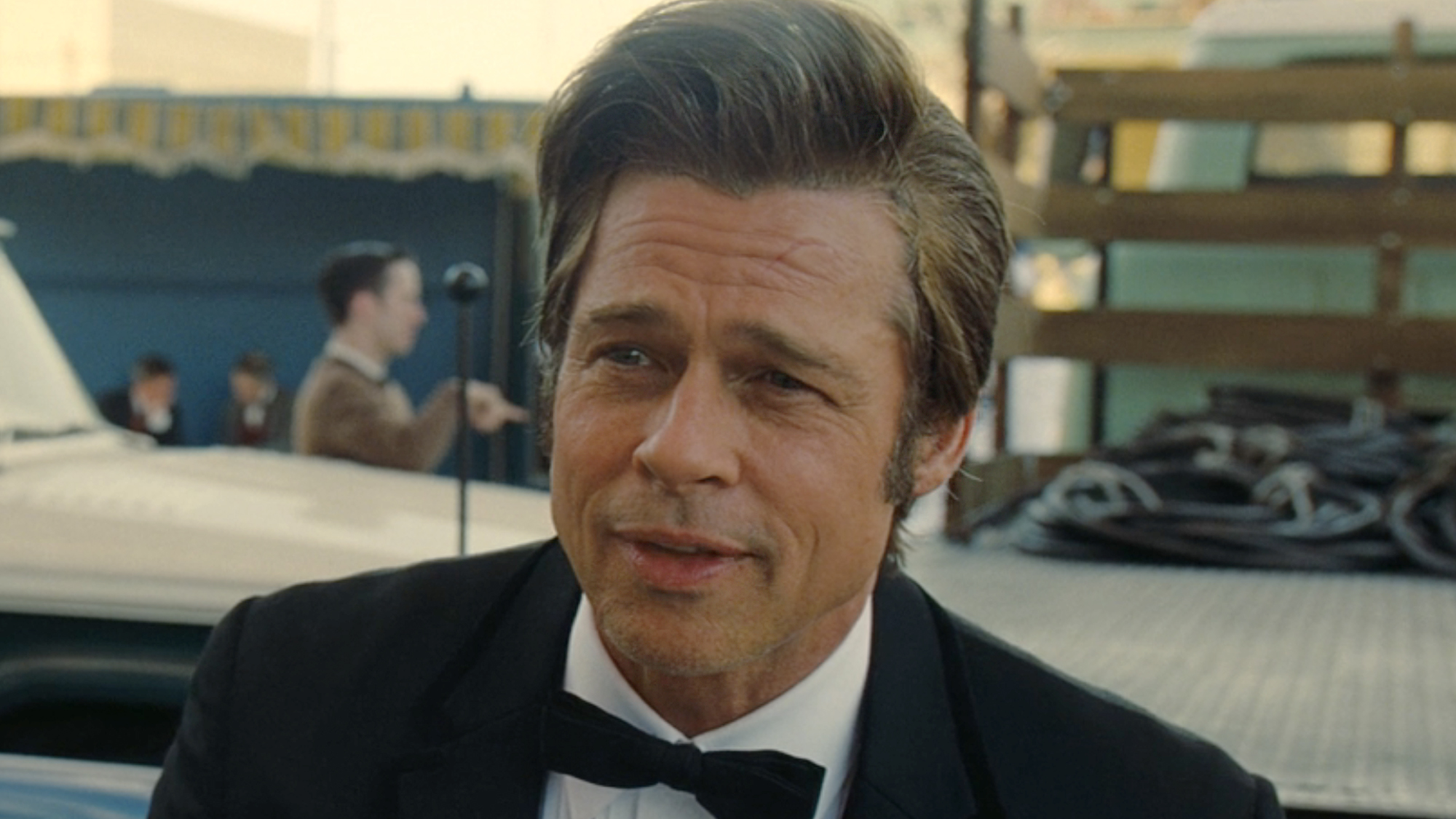 Cliff Booth (Pitt), dressed in a tux, waits on set in Once Upon a Time... In Hollywood (2019).