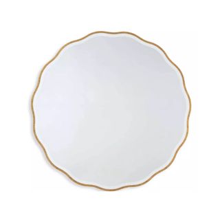 A gold circular mirror with a wavy border
