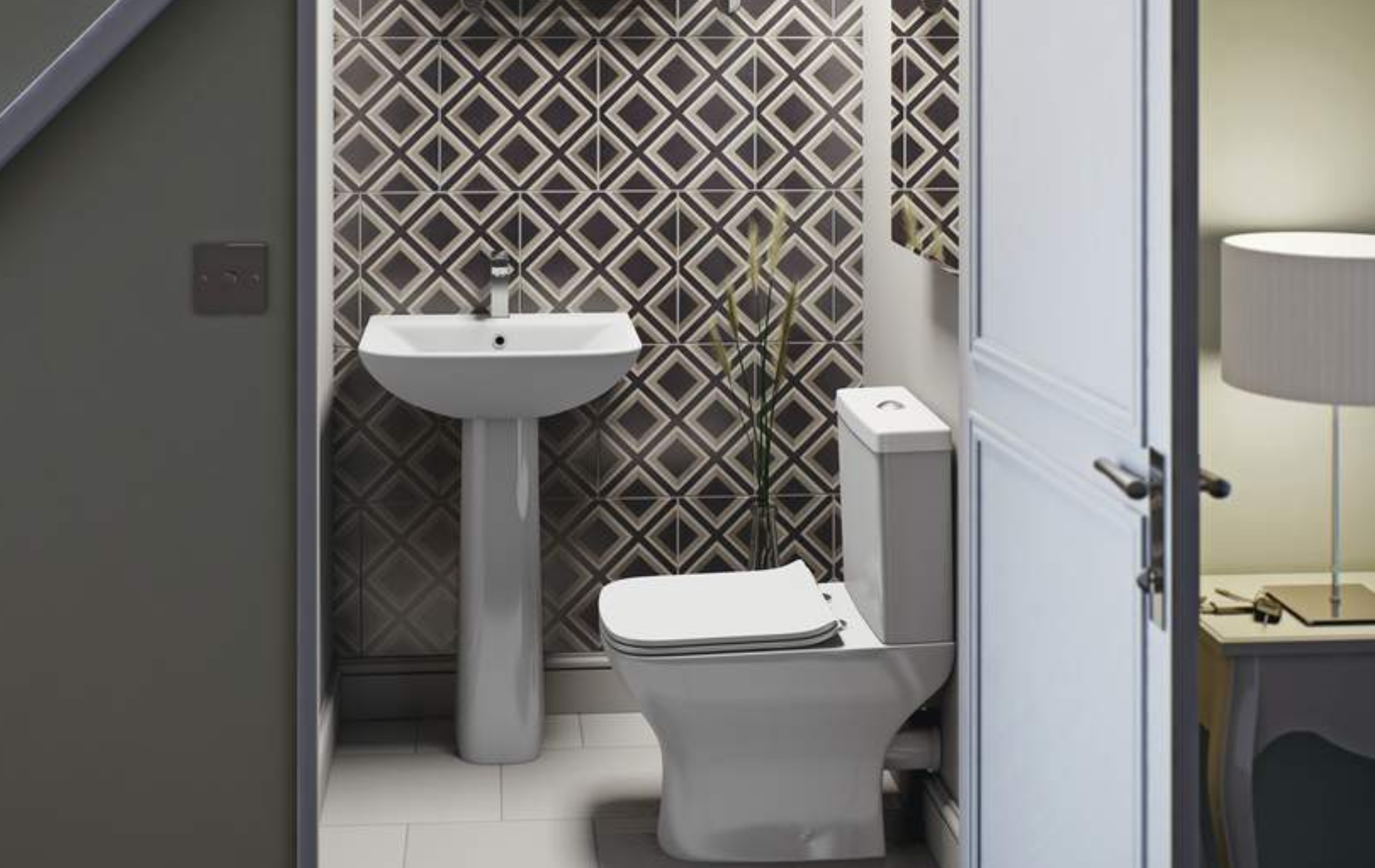 Understairs toilet idea with geometric tiling feature wall