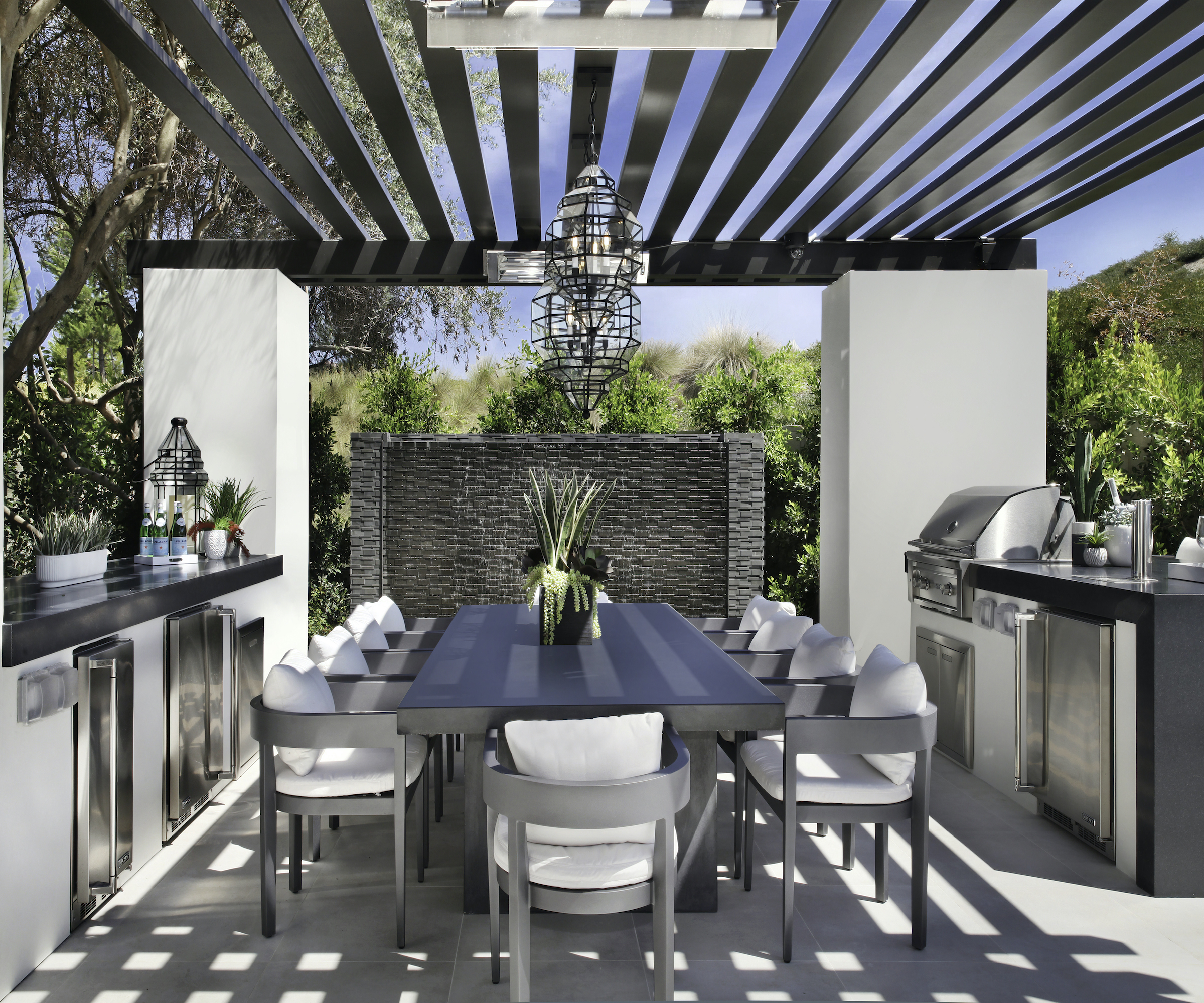outdoor kitchen with steel and dining furniture
