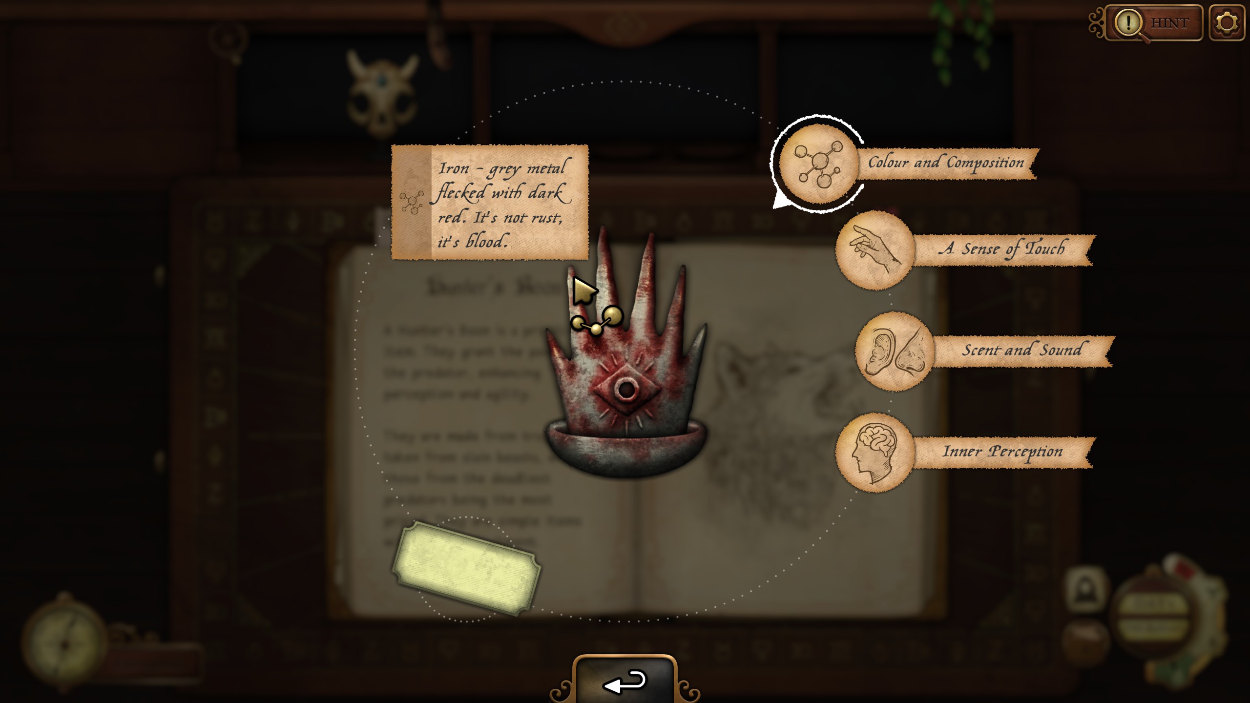 A hand-like object with blood on it being examined