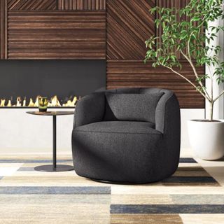 A rounded dark gray armchair