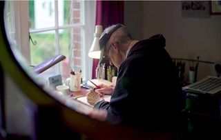 The 84-year-old author and illustrator working in his studio at home