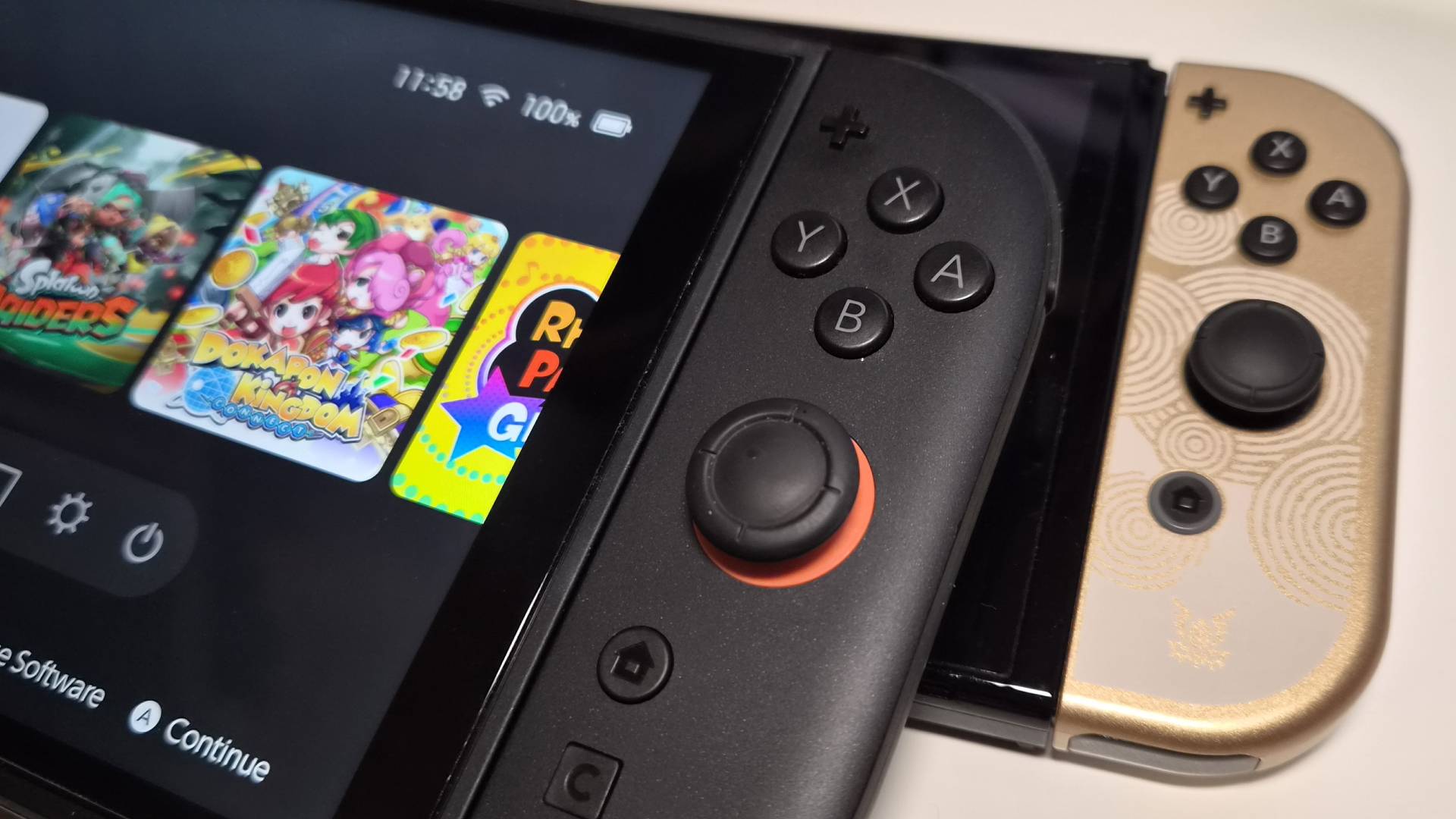 Photo of a Nintendo Switch 2 sitting on top of the Tears of the Kingdom OLED Switch console.