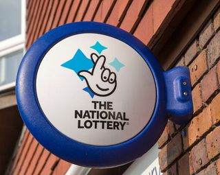 Wall mounted sign for the National Lottery