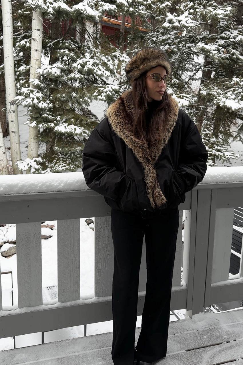 Bettina Looney wearing a fur-trimmed jacket in the snow