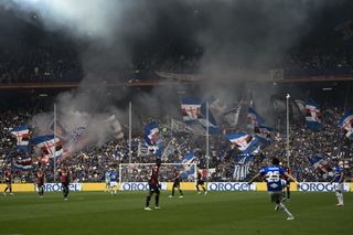 Fans of Sampdoria wave flags during a derby against Genoa in April 2022.