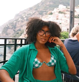 Woman with a curly bob and center part