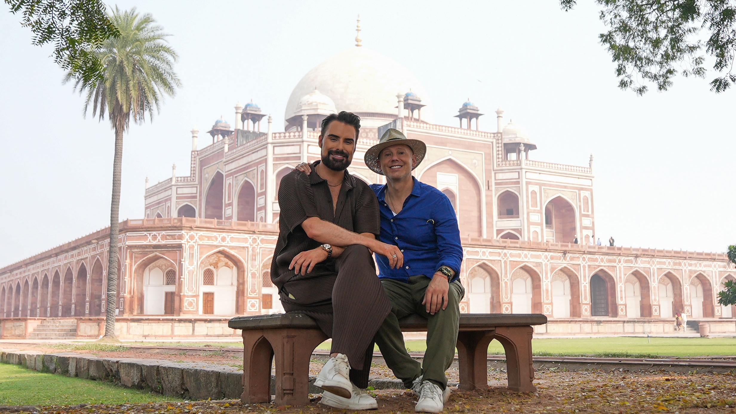 Rob Rinder and Rylan Clark sitting on a bench, outside Humayun&#039;s Tomb.