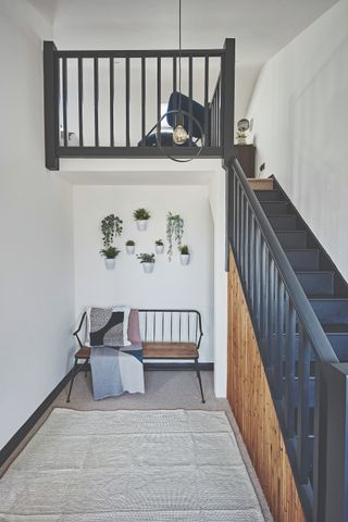 dark blue staircase leading to loft mezzanine bedroom
