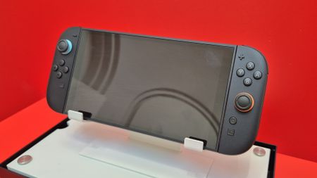 Nintendo Switch 2 console on a stand against a red background