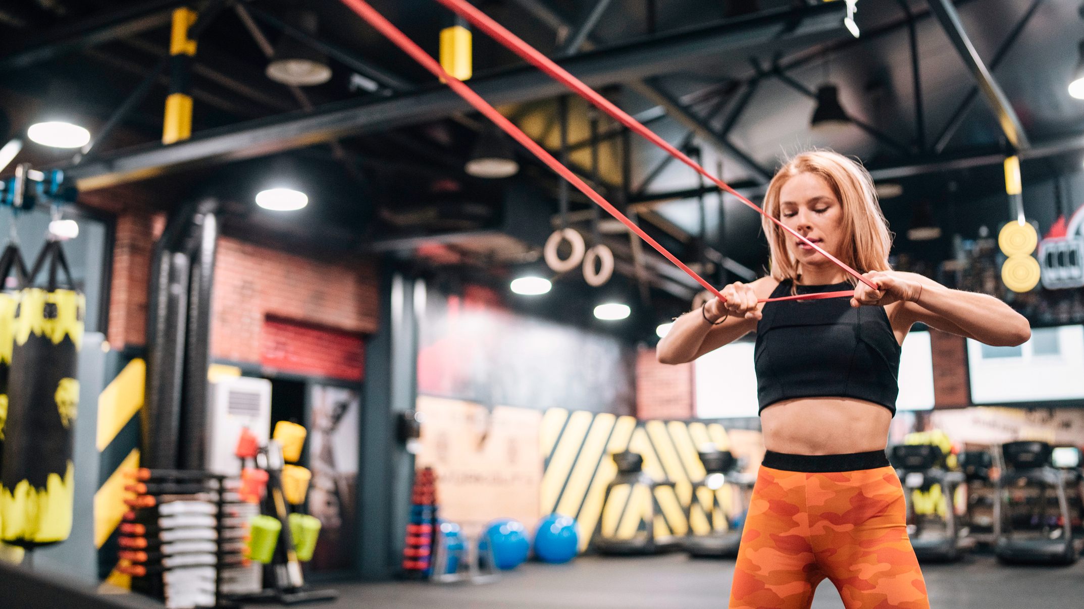 Woman exercising with resistance band in gym