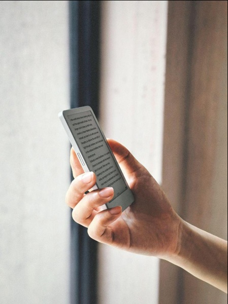 The Boox Picco is a pocket-sized eReader that ifts in the palm of this model's hand for easy reading.