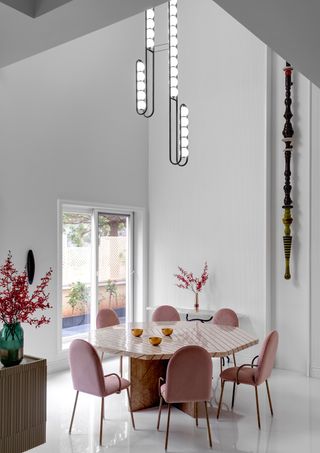 A dining room with long pendant lights
