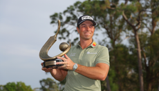 Viktor Hovland poses with the Valspar Championship trophy