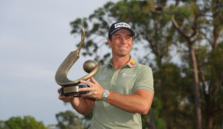 Viktor Hovland poses with the Valspar Championship trophy