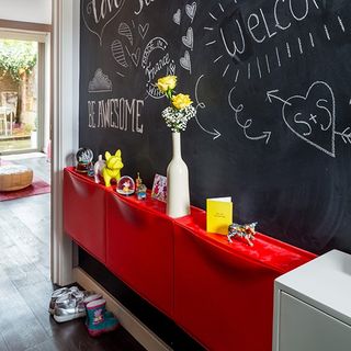hallway with black design wall and red cabinet