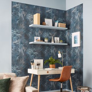 Living room with home office zoned with blue and grey patterned wallpaper