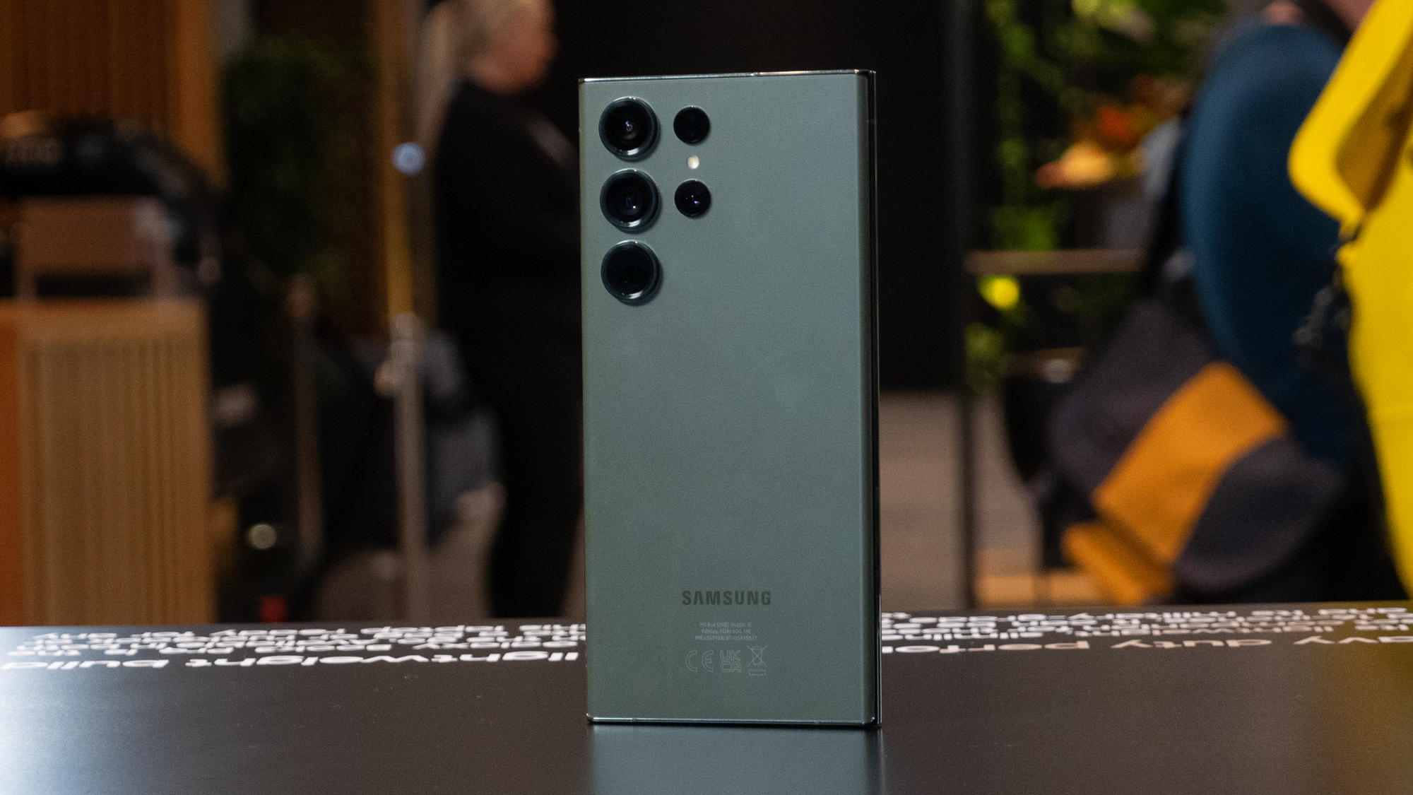 Samsung Galaxy S23 Ultra hands on back green plinth