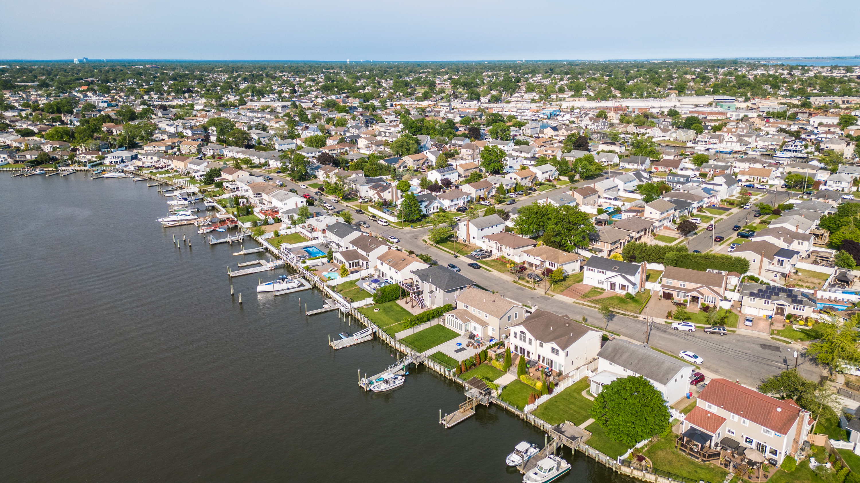 Aerial overhead view of a typical suburban Long Island, New York community with homes, boats, and water.