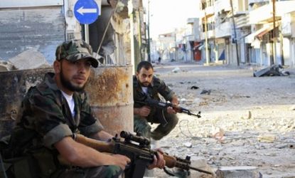 Free Syrian Army fighters patrol a street near Homs, May 5, 2012: The U.N.'s 300-member observer mission has been suspended due to increased violence.