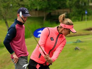Amy Boulden demonstrates how she would like Liam to pitch with his hands a little further from his body