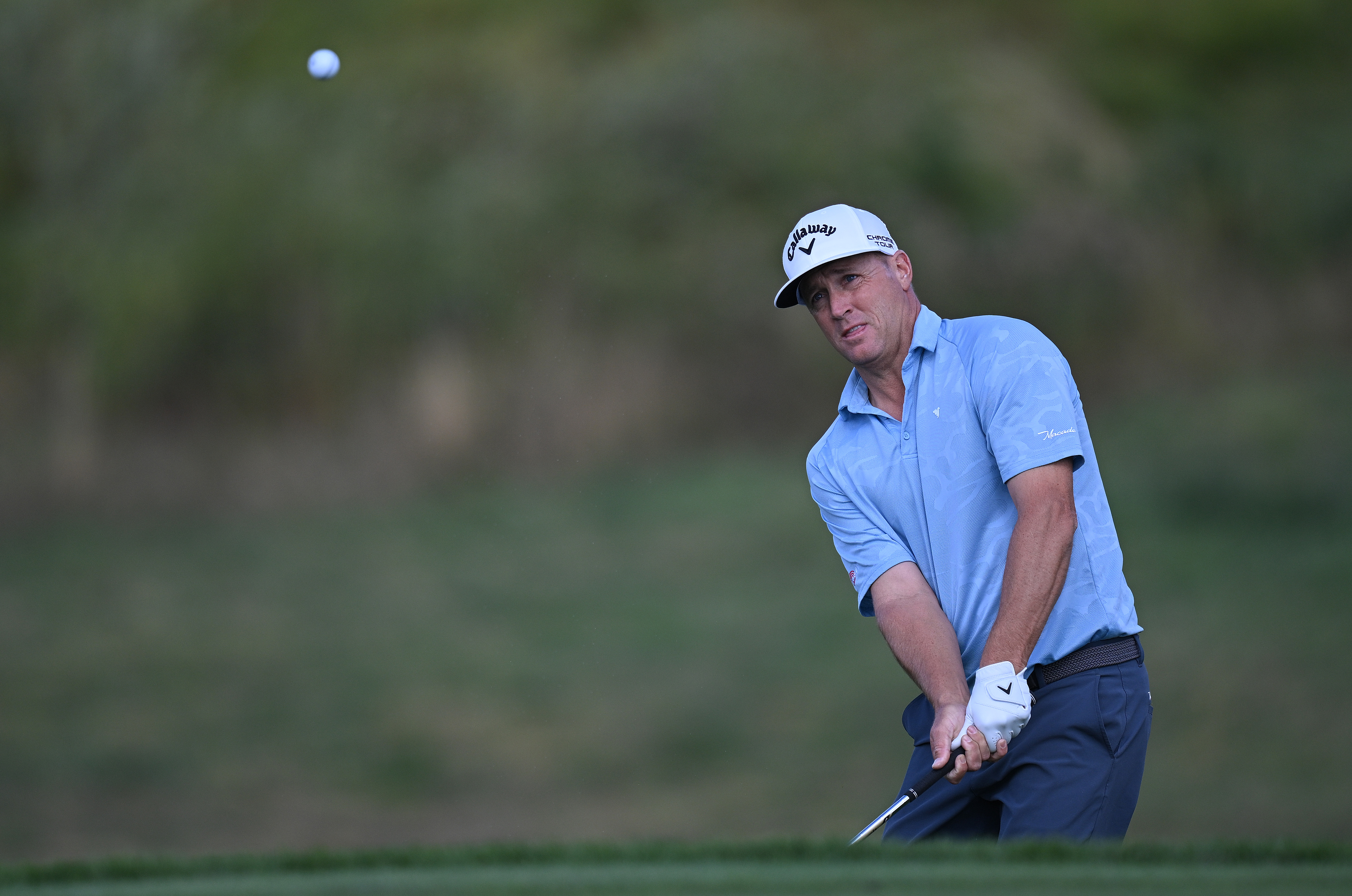 Alex Noren hits a chip shot from the edge of the green
