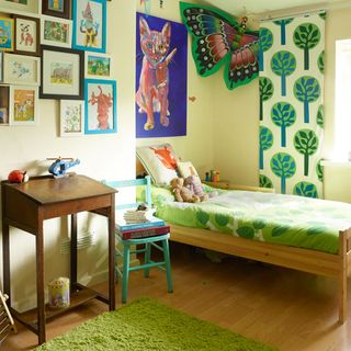 child bedroom with light green painted wall and green rug on floor