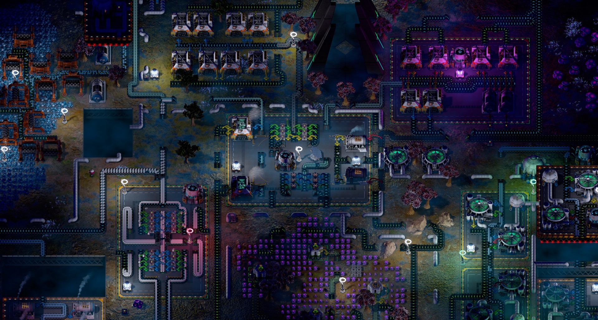 A zoomed-out view of a detailed, complex factory on an alien planet in Substructure at night
