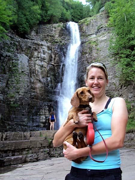 Jo Wall poses with "Cha Cha" in front of Chemin des chutes, a beautiful waterfall just a fifteen minute stroll from the tech area at Mont Sainte Anne, Quebec.