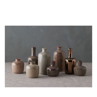 collection of different sized and shaped earth tone vases