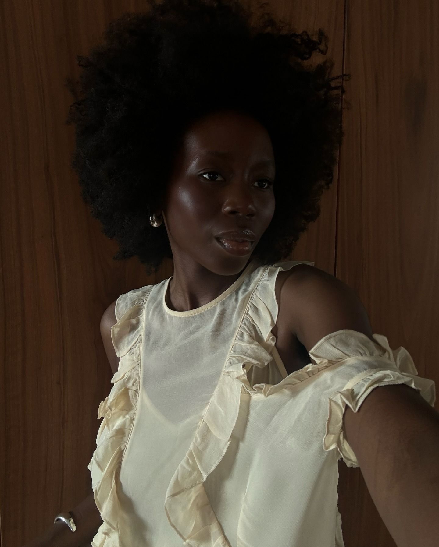 danielle wears a ruffle blouse.