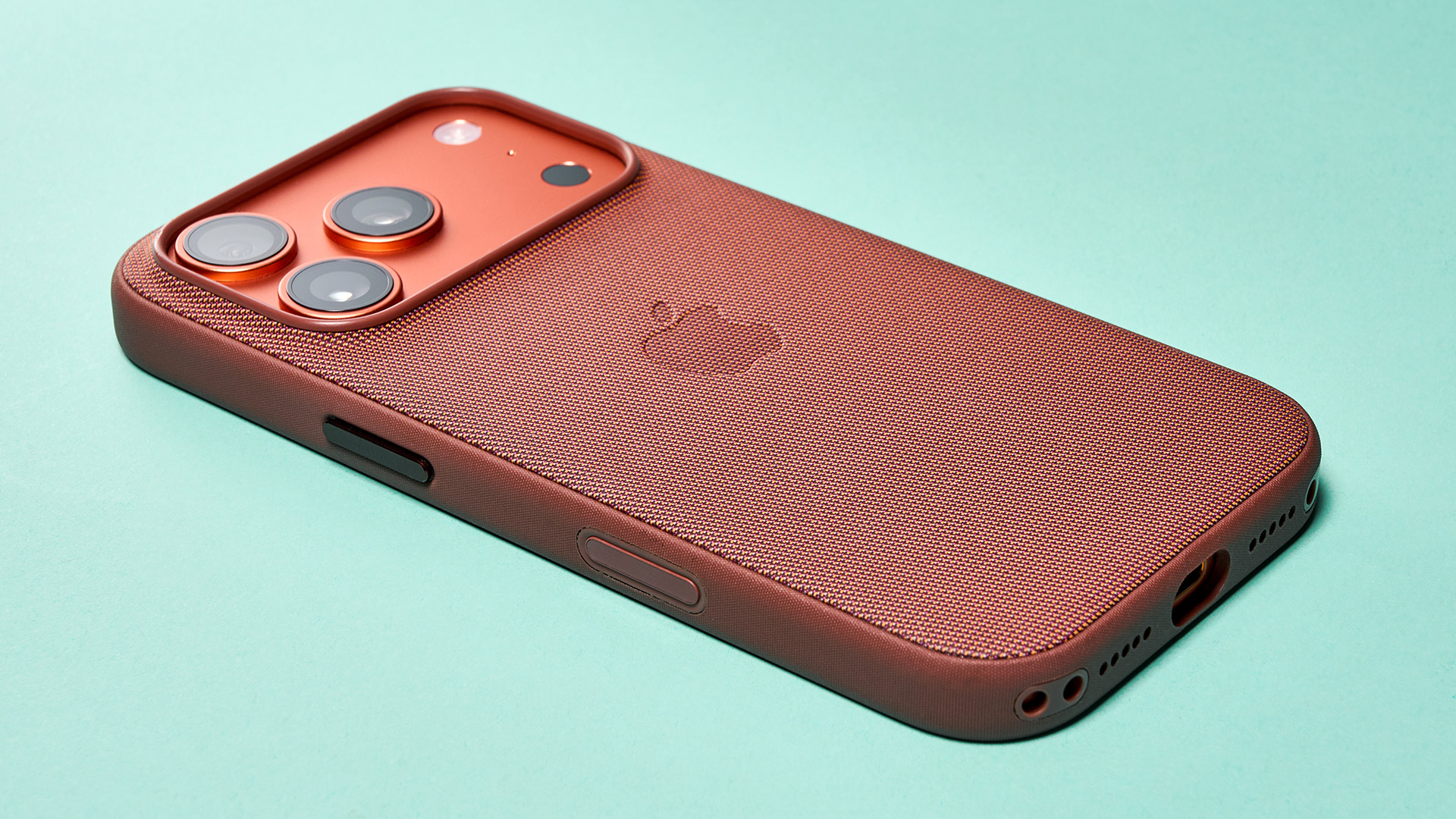 Apple iPhone 17 Pro in cosmic orange on green background