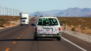 A car drives with "Area 51" written on the back before the start of a "Storm Area 51" spinoff event called "Area 51 Basecamp" on September 20, 2019 near Alamo, Nevada.