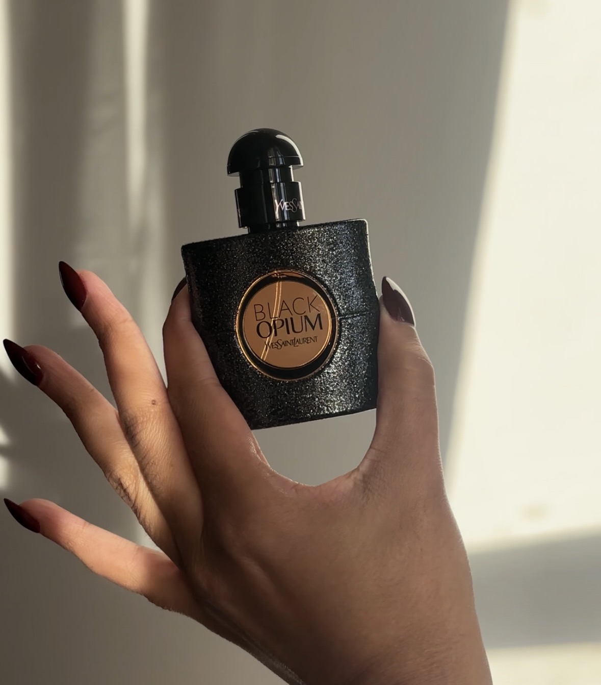 bottle of yves saint laurent fragrance, held by the author